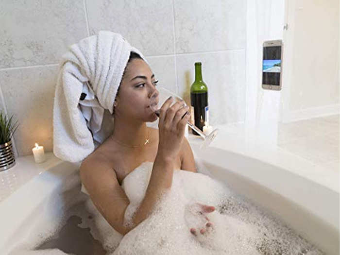 A shower curtain that holds tech so they can watch tv in the shower