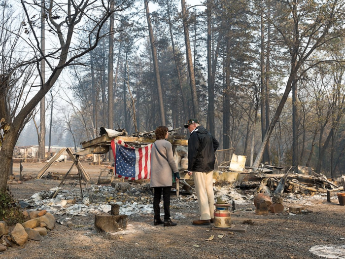 Nov. 17, 2018: Trump speaks with Paradise Mayor Jody Jones as they tour the Skyway Villa Mobile Home and RV Park during his visit of the Camp Fire in Paradise, California.