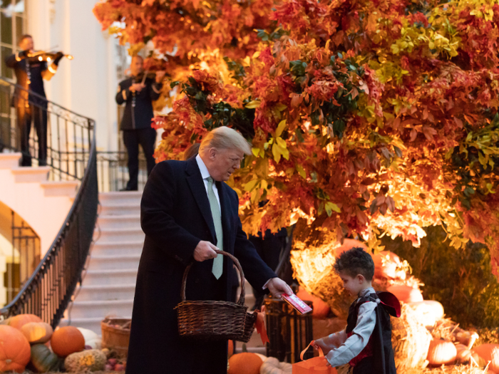 Oct. 28, 2018: Trump hands out candy to children outside the South Portico entrance of the White House at the 2018 Halloween event.