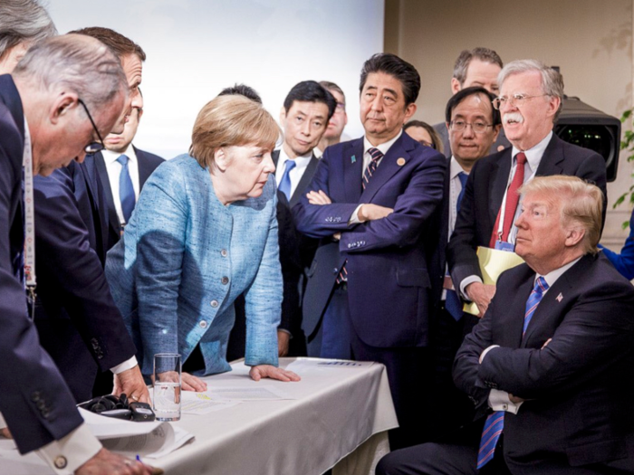 June 9, 2018: German Chancellor Angela Merkel, center, speaks with Trump while surrounded by other world leaders during the G7 Leaders Summit in La Malbaie, Quebec, Canada.