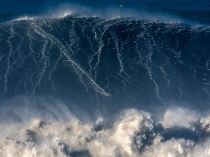 German big wave surfer Sebastian Steudtner drops a wave during a surf session at Praia do Norte in Portugal.