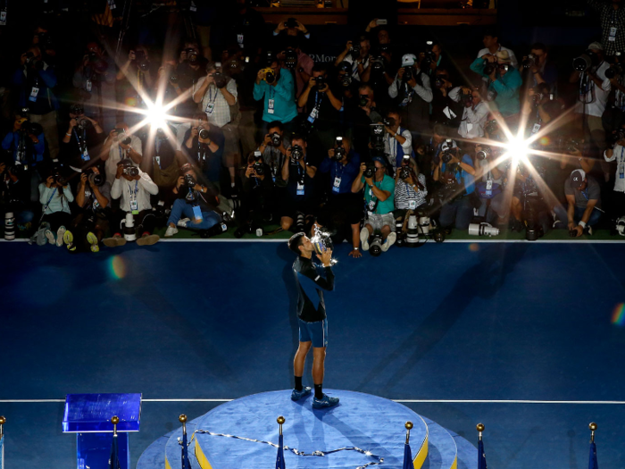 Novak Djokovic kisses his trophy after defeating Juan Martin del Potro to win the tournament.