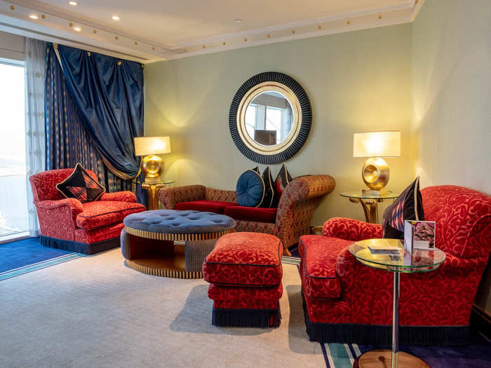 The bedroom has its own sitting room with plush furniture that looks much too nice to actually sit on.