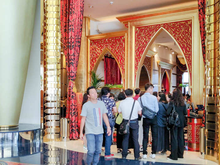 At midday, the hotel is far from calm. The Burj is a big tourist attraction for Dubai and the only way to see it is with a reservation for afternoon tea at one of the restaurants. That means tour buses roll in with groups getting tea and a tour. I