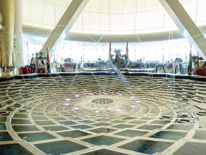 The centerpiece of the atrium is a circular fountain with a geometric structure that appears to mimic Islamic tile art. It periodically shoots water 130 feet into the air.