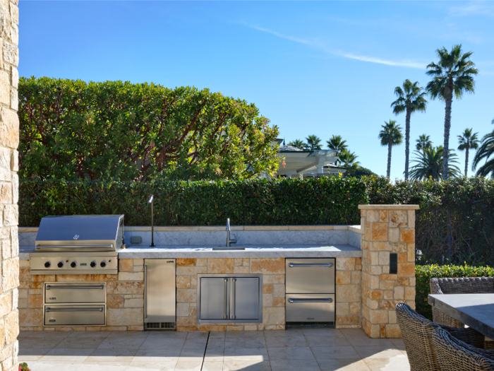 ... and an outdoor kitchen complete with grill and sink.