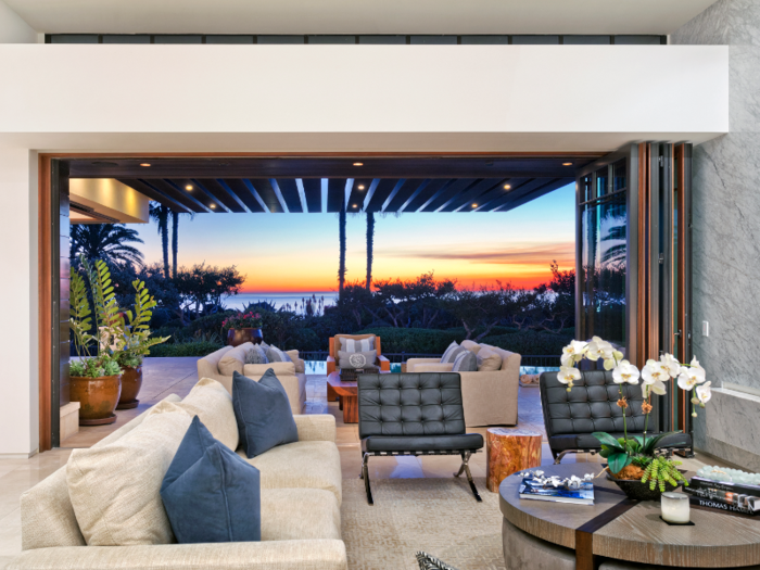 Mahogany and glass doors disappear into the walls, opening up the indoor areas to views of the ocean.