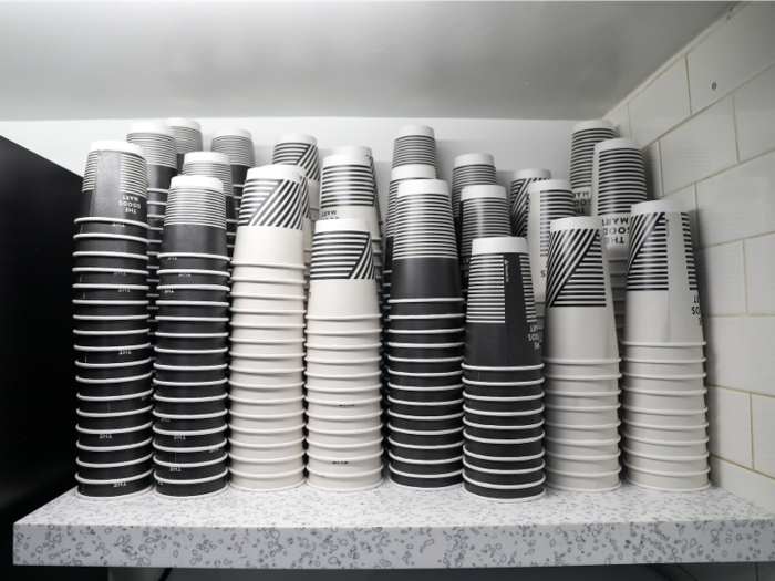 Rows of cups line the counter next to the coffee machine, just as you