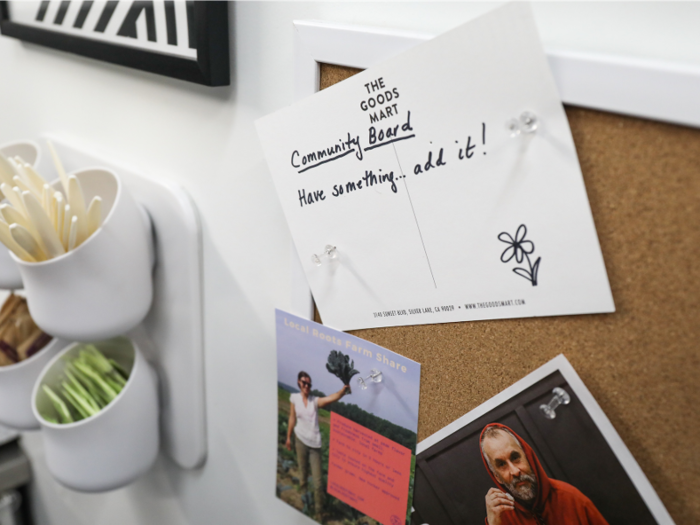 Next to the chip-lined shelves is a bulletin board inviting customers to pin things for everyone to see.