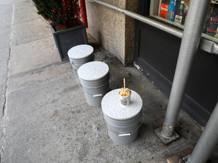 Seats fashioned out of plastic buckets sit outside the New York store — a nice touch.