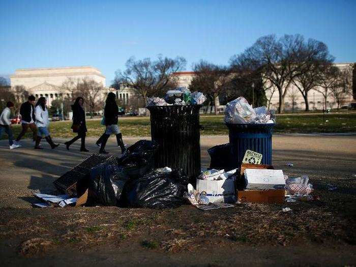 While some locals are chiding citizens for tossing their trash into an already-full bin, others blame the shutdown.