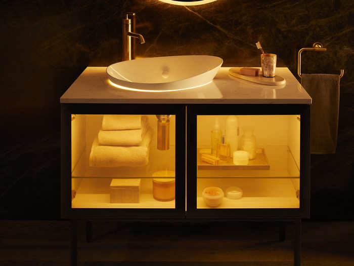 The vanity comes with a sink and glass doors that transition from translucent to semi-opaque.