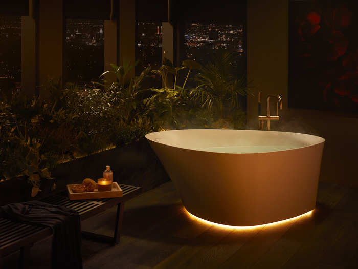 The free-standing bath has sculpted curves and a "gentle illumination," according to Kohler