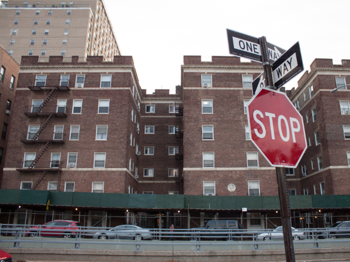 ... surrounded by apartment buildings and homes on three sides ...