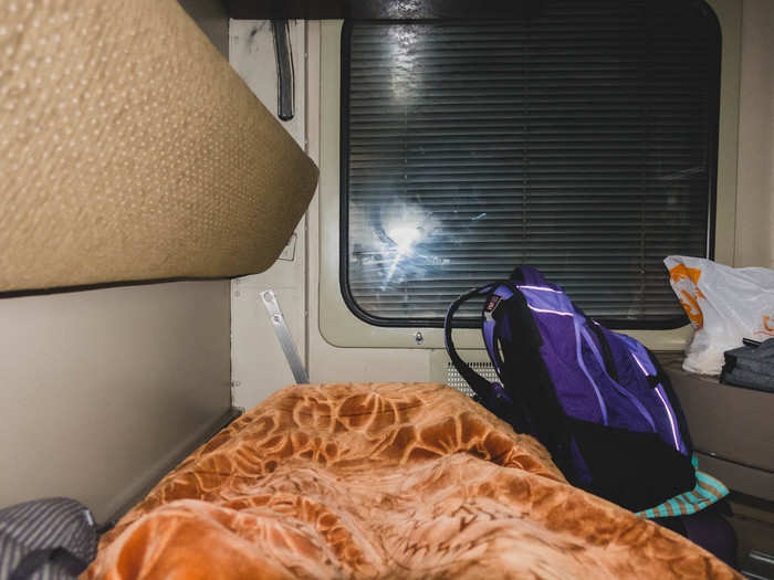 I tucked into bed. The blanket was thick, the bed firm, and the soft pillow proved to be more comfortable than most hostel pillows I’ve encountered. Every so often a lamp along the rail would shine a light into the compartment. Or I