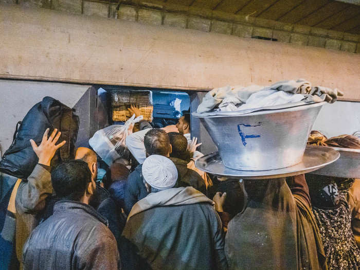 A few trains arrived while I waited for the sleeper. Each time, a madhouse routine ensued. Would-be passengers ran up and down the platform searching for a few inches of space to push themselves into the teeming cars. Fights broke out, curses were shouted, and both men and women attempted to carry absurd and unwieldy items onboard. The trains left with doors open and passengers hanging from the handrails, the hands of brothers, friends, or husbands the only thing keeping them from falling onto the tracks.