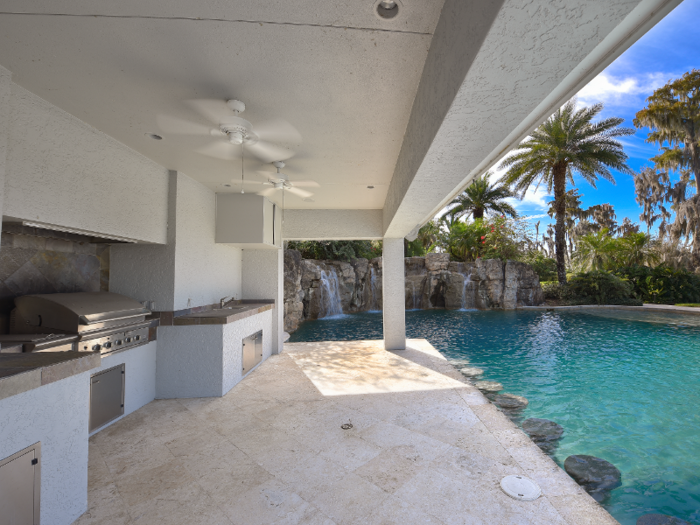 ... and an outdoor BBQ space includes a grill and sink as well as underwater stools, which can make it a poolside bar.