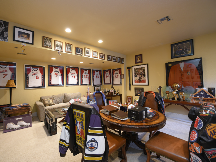 The listing photos show a room full of memorabilia from Shaq