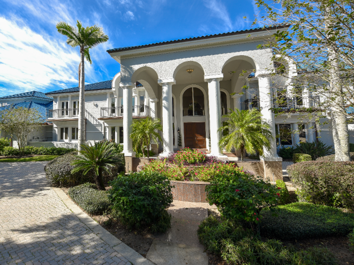 The entryway of the home is marked by stately white columns.