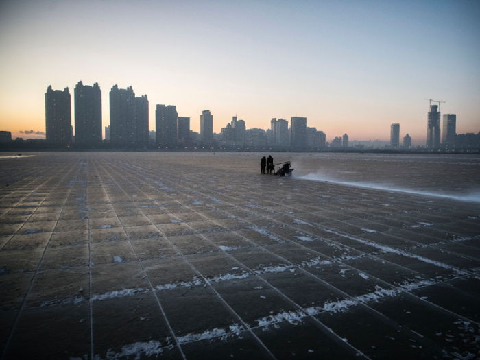 In the weeks leading up to the festival, workers use a machine to cut usable ice blocks from the frozen river.