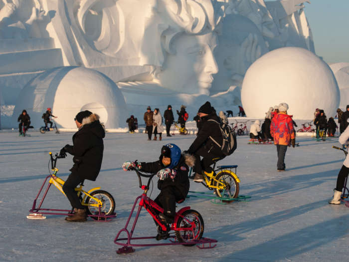 Visitors can even ride ice bikes near the snow sculpture exposition in the Harbin Sun Island theme park.