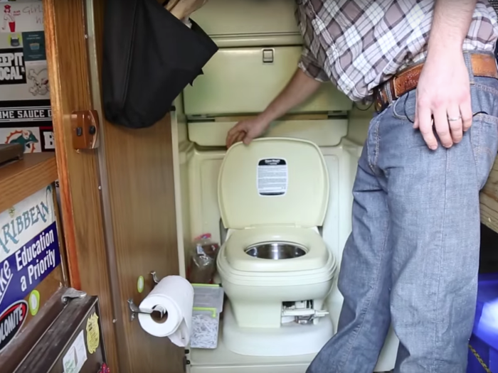 ...and a small compartment opened up to a toilet, sink, and shower.