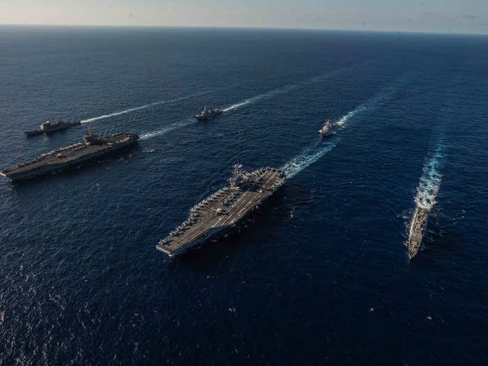 American carriers are never alone in hostile waters.