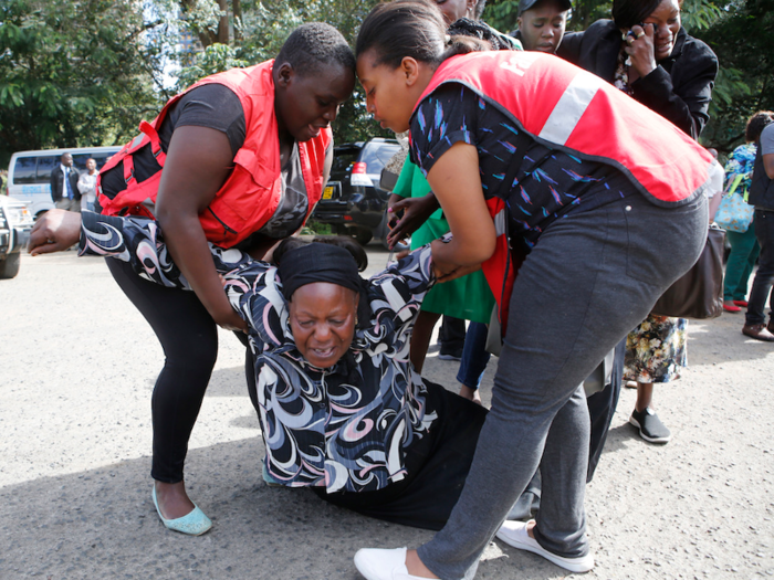 Here, Kenya Red Cross staff support a woman who just learned that her family member was killed in the attack.