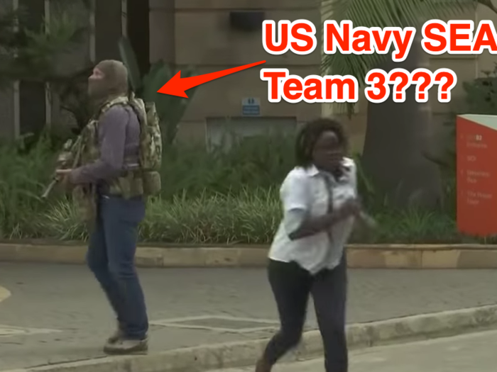 Footage of the attack might have revealed a secretive US Navy mission. This still shows a woman escaping while a masked man wearing a US military-style backpack with a patch used by the US Navy SEAL Team 3 stands guard.