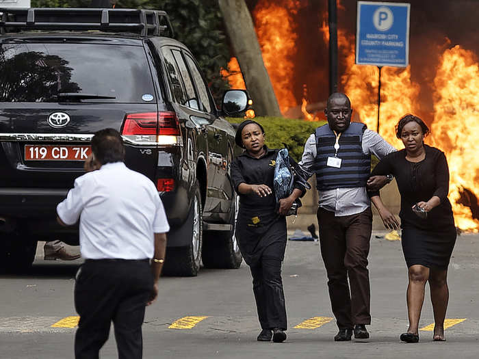 Witness Lucy Wanjiru told The Associated Press that she saw a woman on the ground floor get shot. She hid in a bathroom with several other people, and stayed on the phone with her friend overnight. Here, security forces help civilians flee.