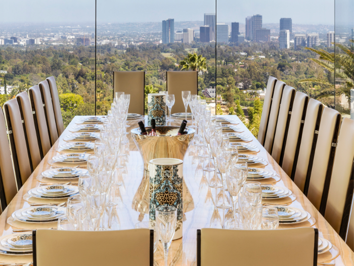 Glass walls throughout the home provide unobstructed views of mountains, ocean, and the Los Angeles skyline.