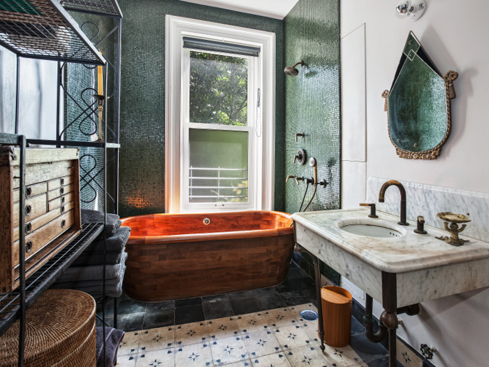 The home has two full baths — including this beautiful, rustic bathroom — and one half-bath.