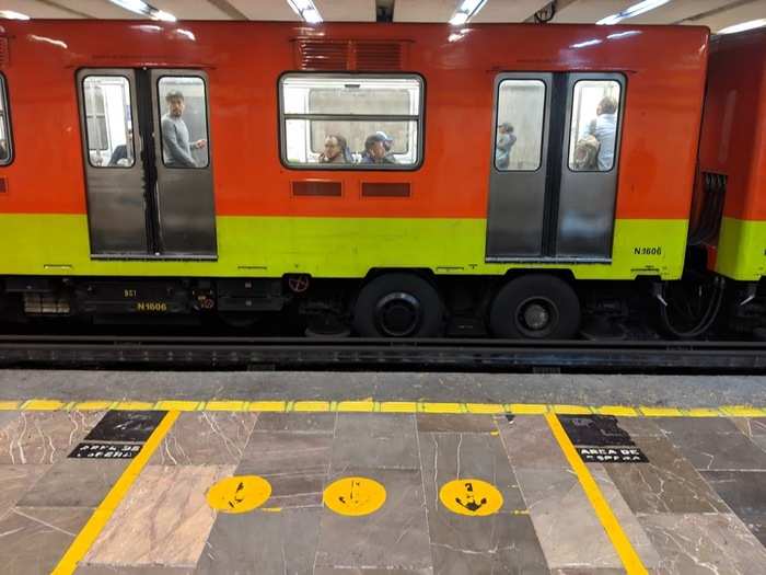 Yellow lines mark where the doors will open when a train pulls in. "Let people off before boarding," a sign reads above each door.