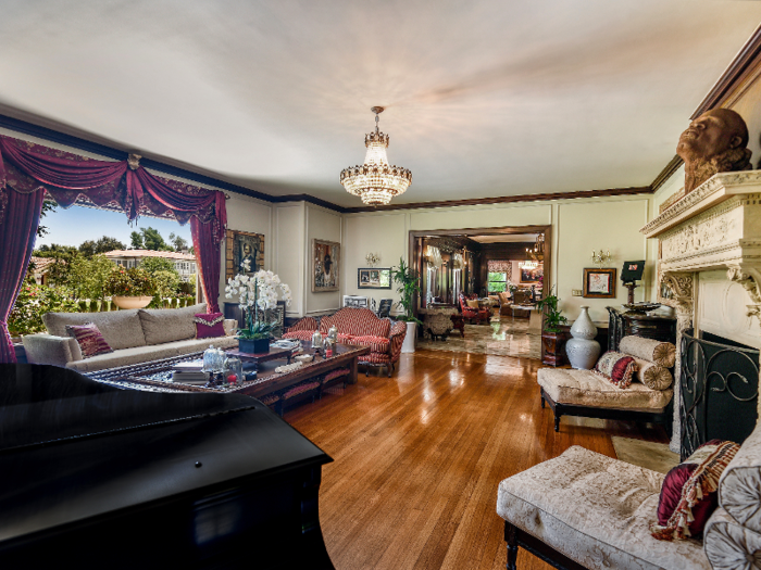 The 14,500 square foot home is furnished with plush furniture, antique chairs ...