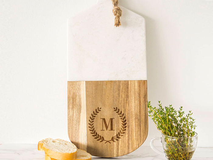 A monogrammed marble and wood serving board