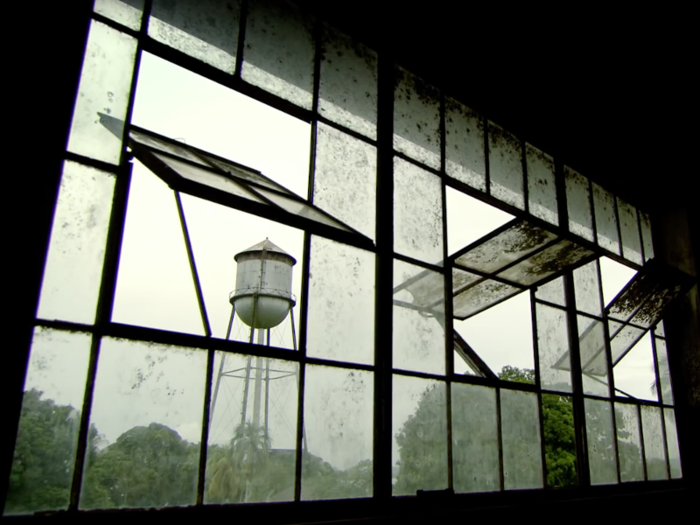 The water tower still boasts a faded Ford logo.