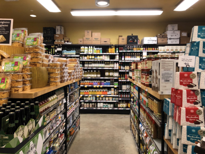 The meat section is surrounded by a few small aisles containing olive oils and sauces.