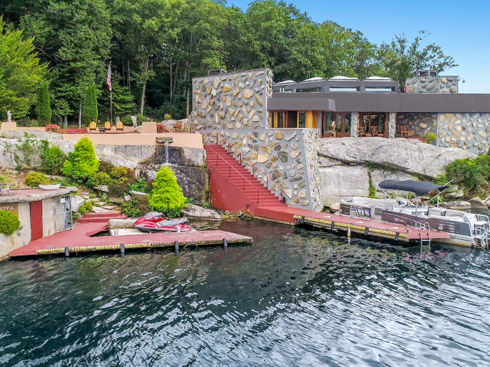 A staircase leads down from the house to the boat dock.