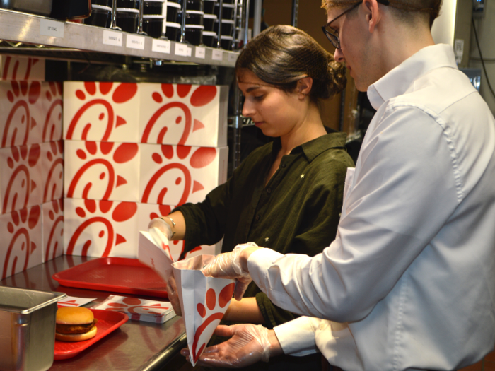 Opening the bag is an art of its own. Adam Hall, a team member at the Fulton Street location, told me to hold the packet open with my non-dominant hand and insert the sandwich with my dominant hand. Sounds easy, but it