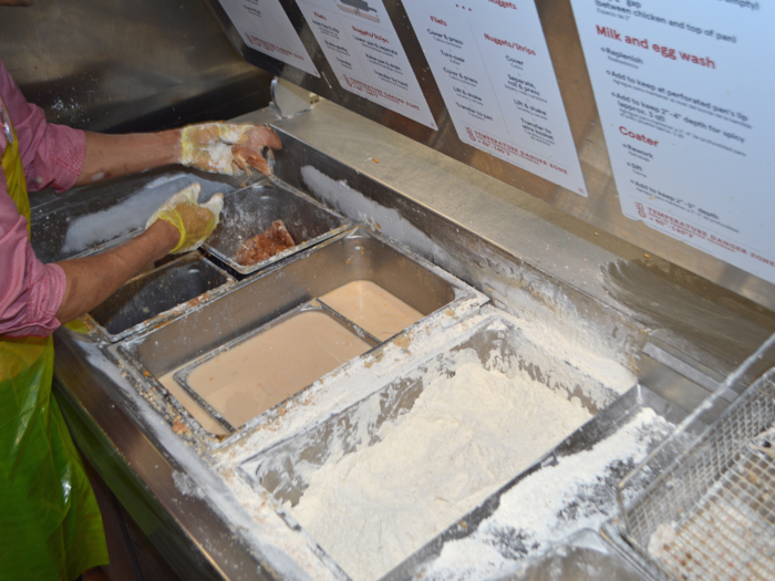 The first stop is the breading station. Inside the giant metal box are several bins with all the necessities for breading fillets ...