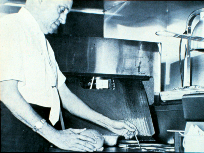 He modeled the cooking process off of the way his mother would fry chicken at home: She would put a lid over the stove to create a sort of pressure cooker, which allowed the chicken to cook more quickly and evenly.