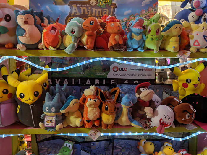 On the other side of the entrance is a massive wall of plush Pokémon and Nintendo characters. This is the first hint that Pink Gorilla is something unique — these aren