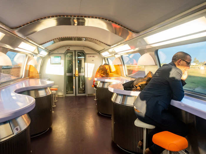 The cafeteria car had a retro futuristic vibe with its curved ceilings, wavy bar table, and colorful stools.