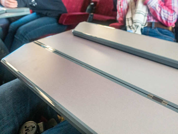 The tray table on the double rows folds out for each person. It