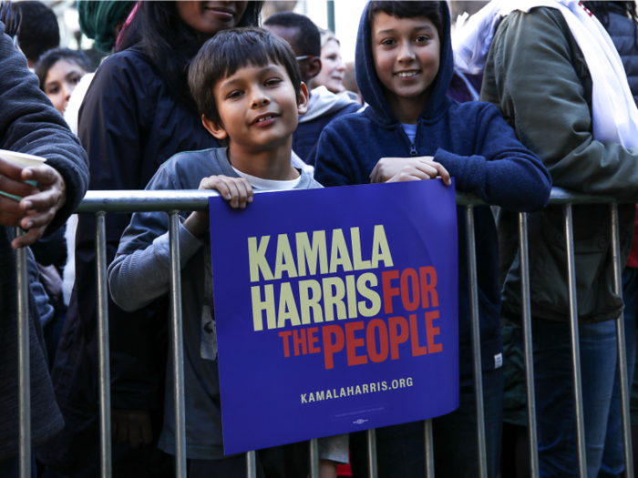 People carried vibrantly colored posters in support of Harris.