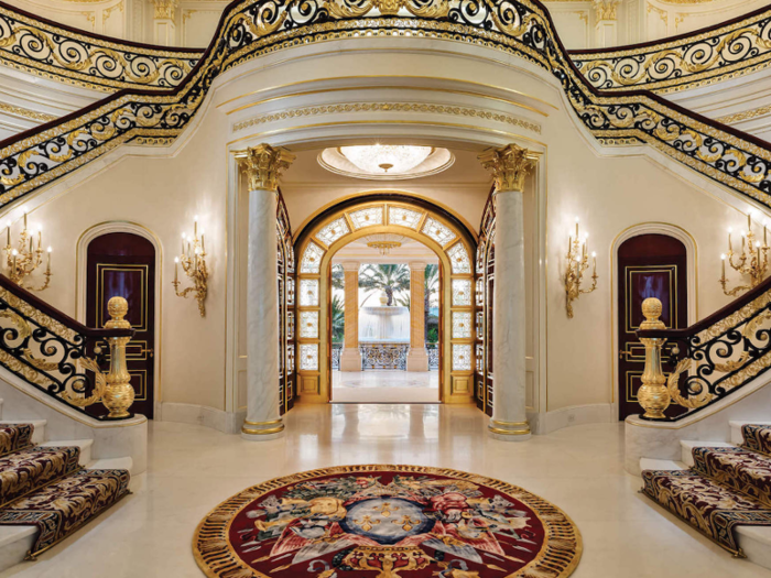 Through the doors is a grand foyer and a staircase crafted out of imported South African marble.