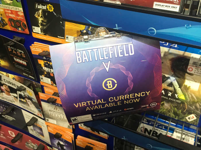 A sign advertising virtual currency to use in-game for "Battlefield V" hung next to the downloadable games.