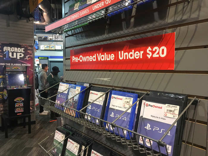 Stacks of pre-owned games priced under $20 sat nearby.