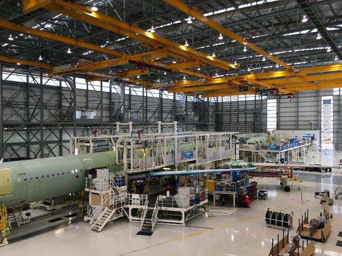 The factory is structured to have parts enter the hangar on one end and...