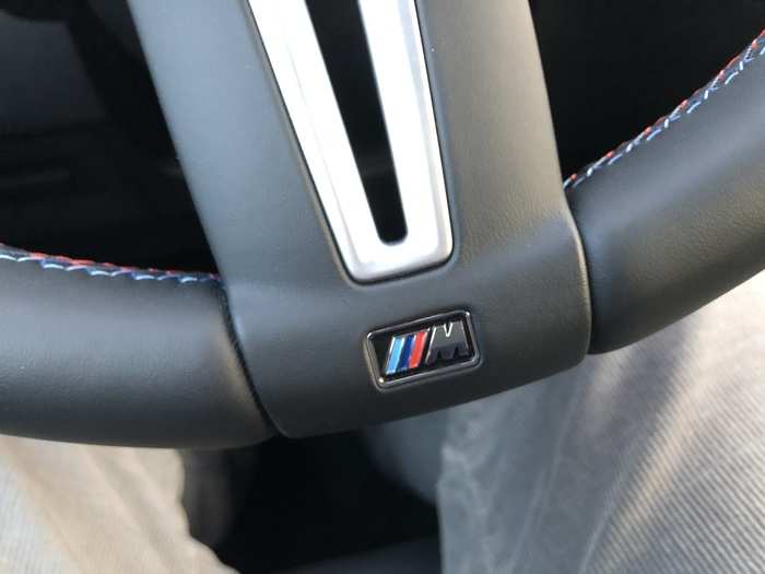 You can just make out the blue-red M Sport signature cross-stitching on the leather-wrapped steering wheel.